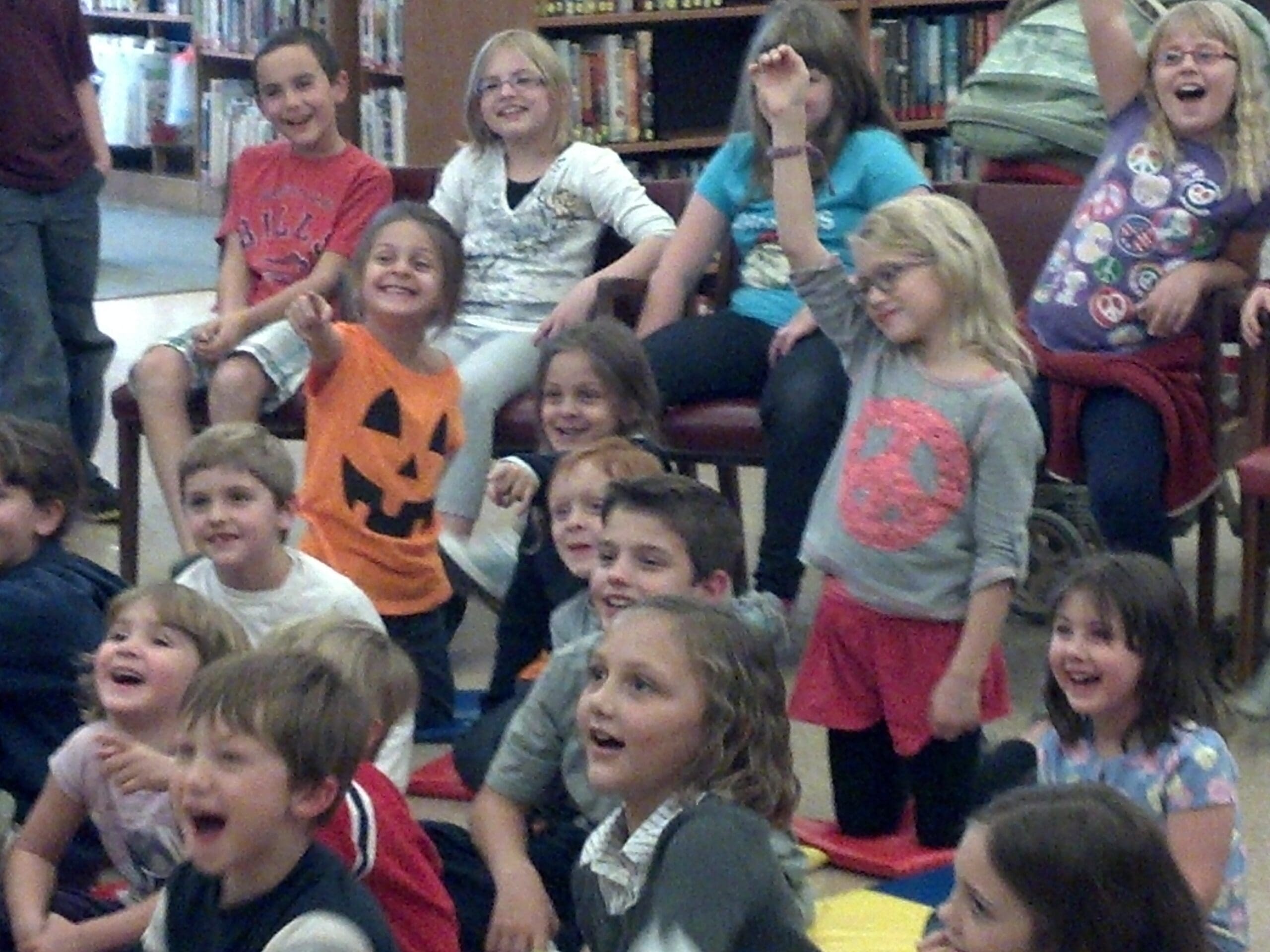 Kids wanting to help Dave in his magic show.